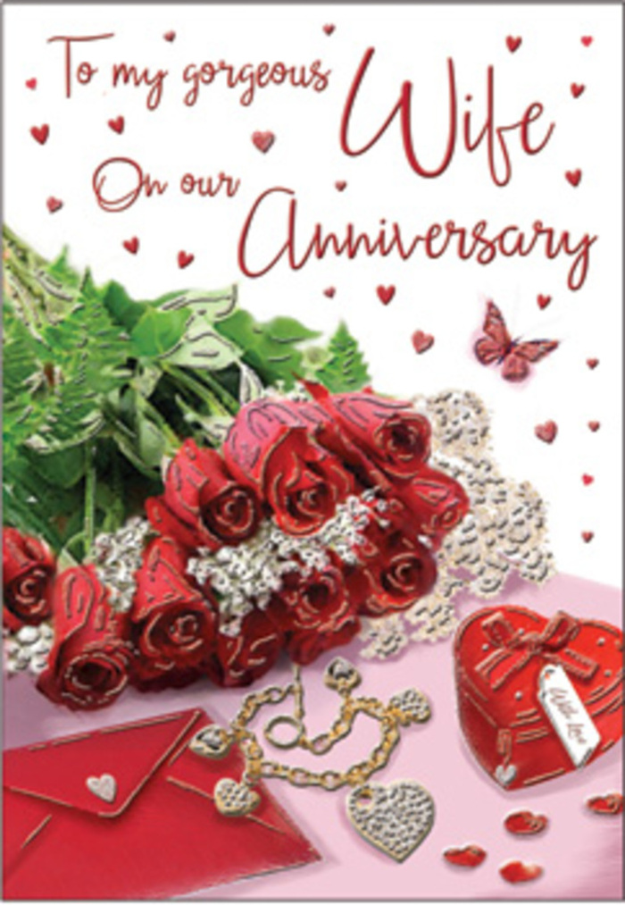 A richly romantic anniversary design unfolds like a still life on a polished tabletop, set against the tranquil backdrop of Sydenham Hill living. At its heart, a generous cluster of red roses, each bloom perfectly unfurled, forms a natural focal point. Their intense crimson colour feels both passionate and reassuring, the kind of classic red that has long symbolised enduring love. Between the roses, glossy green leaves weave in and out, bringing a fresh, garden-picked look that recalls the greenery of Sydenham Hill Wood and the quiet paths that wind through it. Just alongside, an ivory envelope rests in a relaxed diagonal, its surface smooth and slightly luminous in the soft daylight. A heart-shaped keepsake box, finished in a rich red tone to match the flowers, sits within easy reach, its curved lid echoing the rounded petals of the roses. Nearby, a delicate piece of jewellery glints with understated shine, suggesting a treasured anniversary gift, while tiny heart confetti scatters across the surface like memories gathered over the years. The card's message is printed in a flowing script, gently curving among the surrounding decorations so that text and imagery feel seamlessly intertwined. A single butterfly motif hovers at the edge of the composition, lending a whisper of whimsy and the idea of love that continues to evolve. The overall lighting is warm yet gentle, softening shadows and lending a golden hush, as if captured in the early evening before a celebration. Crafted with the eye of an experienced local florist, this design expresses the tenderness of long-term commitment, perfect for couples marking special milestones in and around SE26.